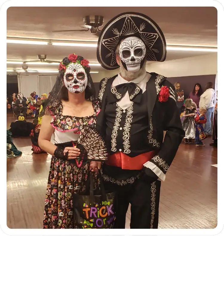A man and a woman dressed in detailed Day of the Dead (D&iacute;a de los Muertos) mariachi and Catrina costumes at a Halloween party event at Kountry Resort Campground.